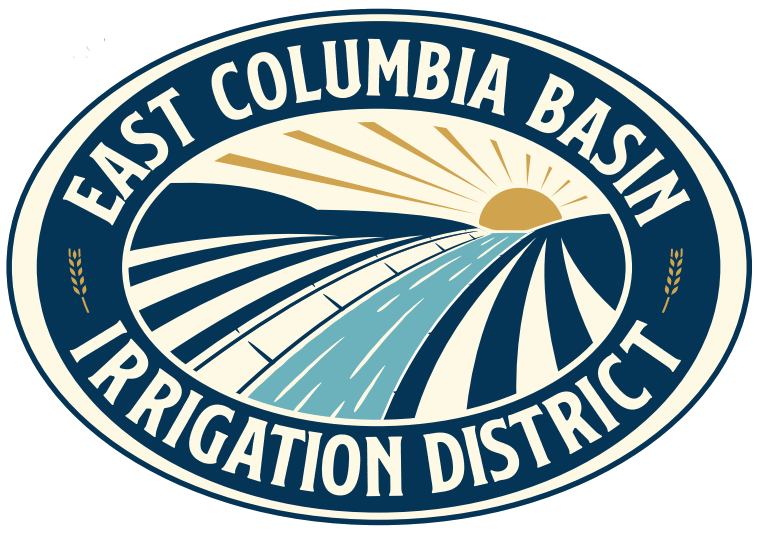 circular logo used by the East Columbia Basin Irrigation district with a canal full of water underneath a sun